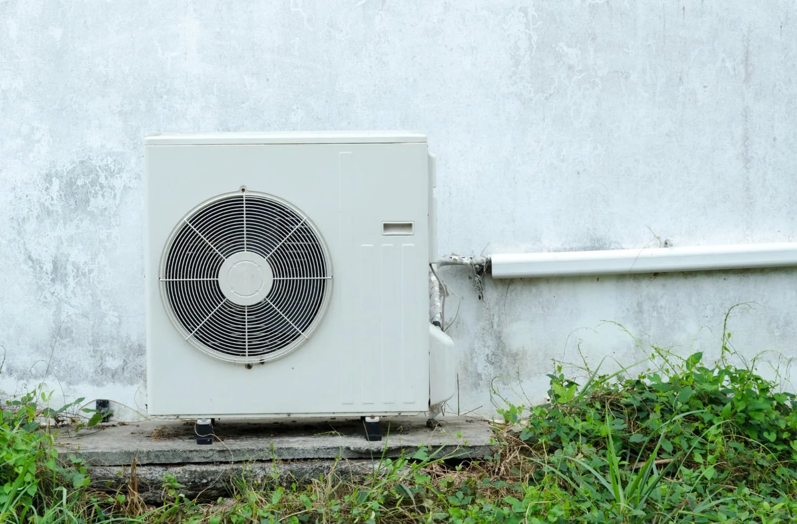 Outdoor heat-pump unit beside a home